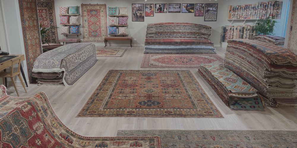 Handmade rugs and hand-embroidered cushions displayed in showroom in Petworth West Sussex